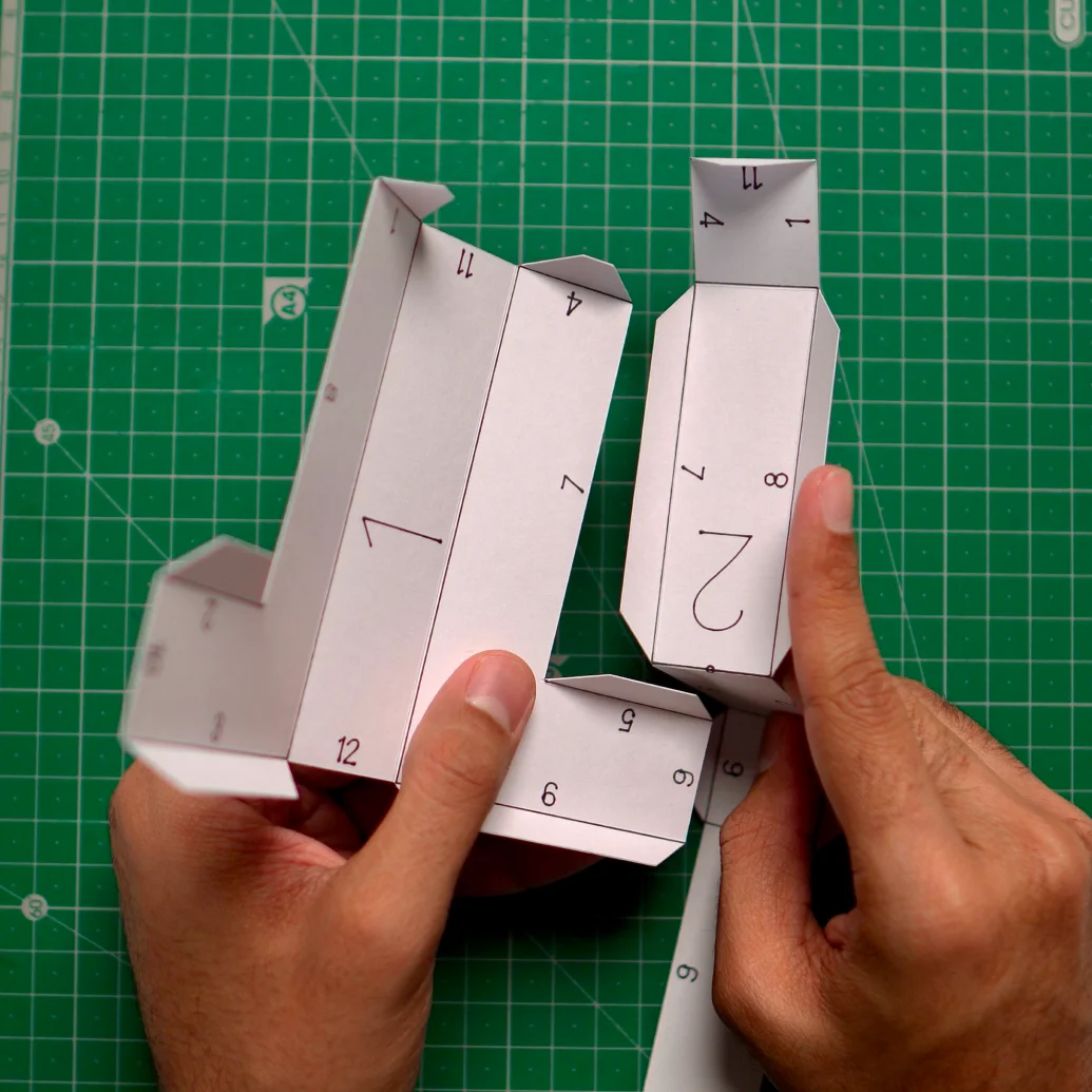 Both paper pieces folded along their printed lines, ready to be glued